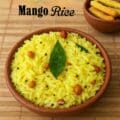 Traditional South Indian mango rice made with grated mango, turmeric, and tempering spices, served in a clay bowl with crunchy snacks on the side.