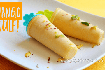 Creamy mango kulfi popsicles garnished with chopped nuts and saffron strands on a rustic plate