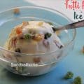 Creamy tutti frutti ice cream scooped using an ice cream spoon, set against a summer backdrop