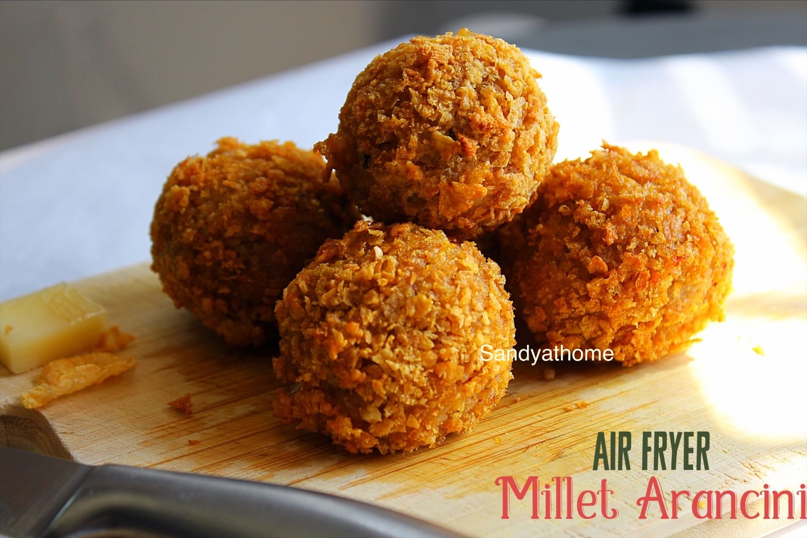 Crispy kodo millet arancini on a rustic plate