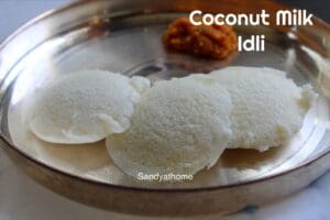Soft coconut milk idlis served on a white plate, perfect for South Indian breakfast.