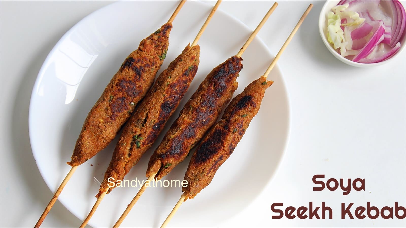 Golden brown veg kebabs made with soya chunks and mashed potato, skewered and ready to serve