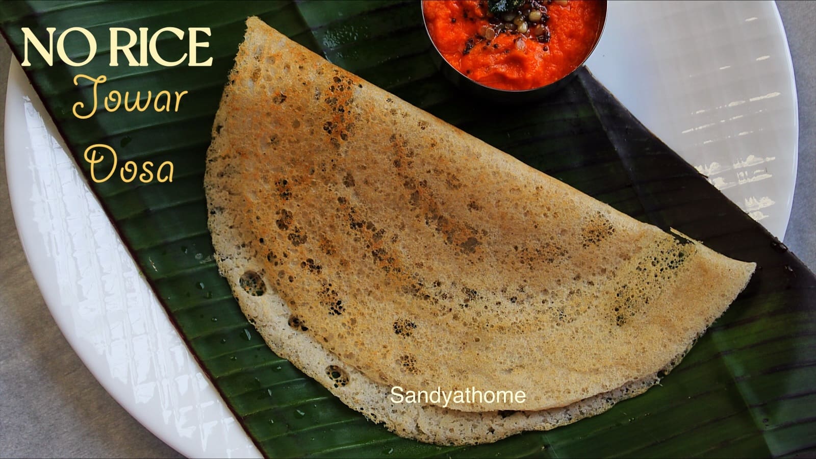 Golden crisp jowar dosa cooking on tawa, no rice millet dosa, healthy vegan Indian breakfast