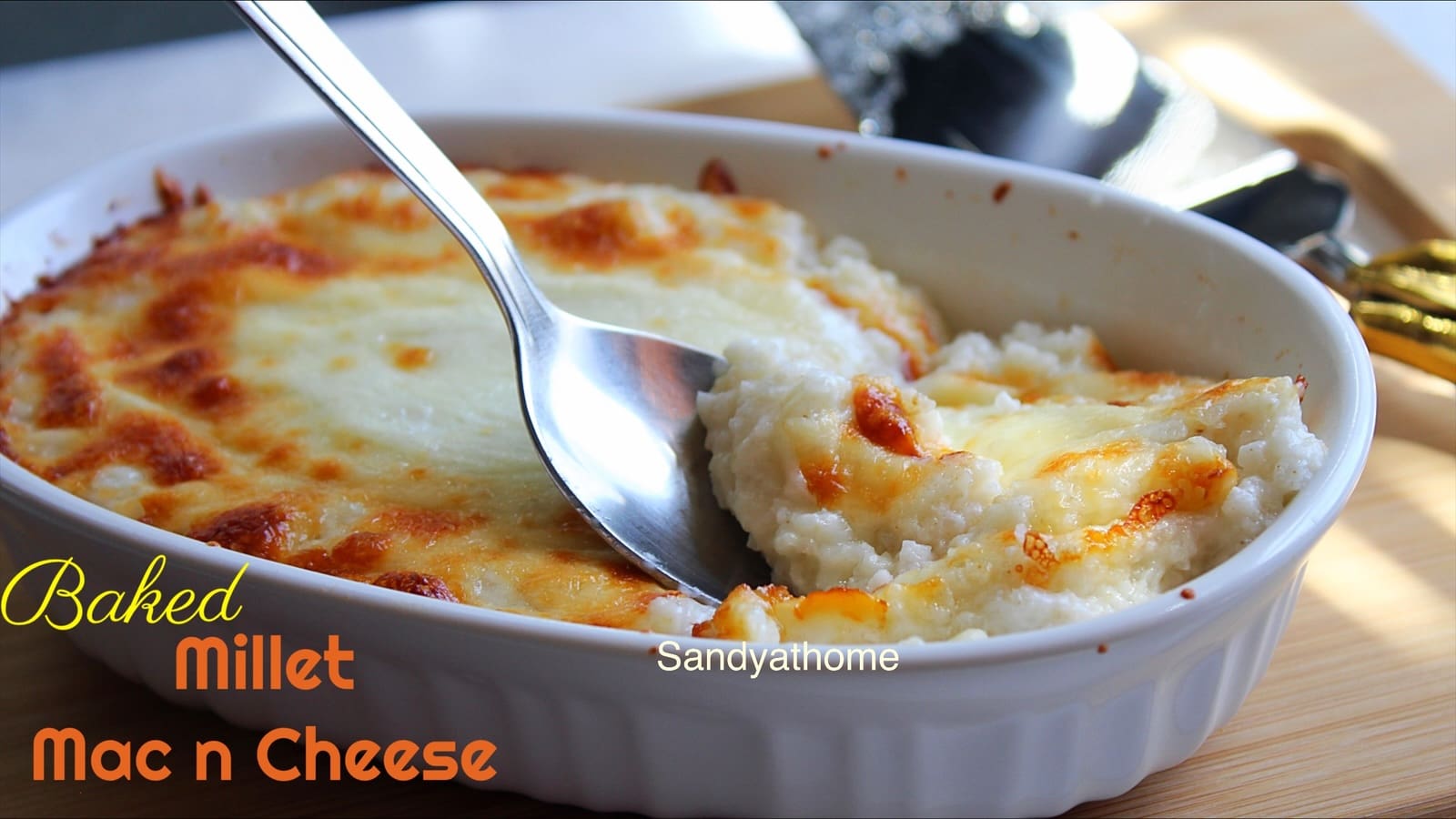 Close-up of baked millet mac and cheese topped with melted mozzarella, a wholesome fusion comfort food.