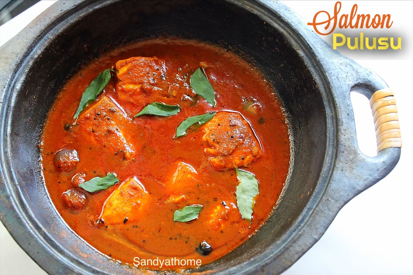 Andhra-style chepala pulusu made with tamarind gravy and thick salmon pieces in gingelly oil.