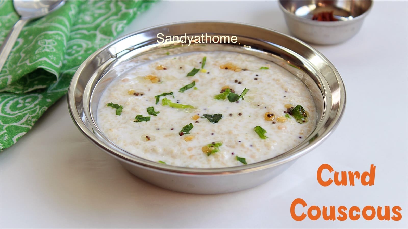 Easy summer meal made with couscous and curd topped with curry leaves and mustard seeds.