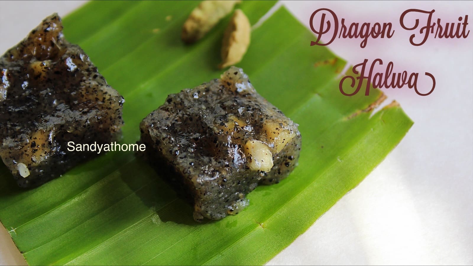 Dragon fruit halwa made with cornflour, brown sugar, and ghee, set into glossy squares and served on banana leaf – a traditional Indian fusion dessert recipe by Sandyathome.