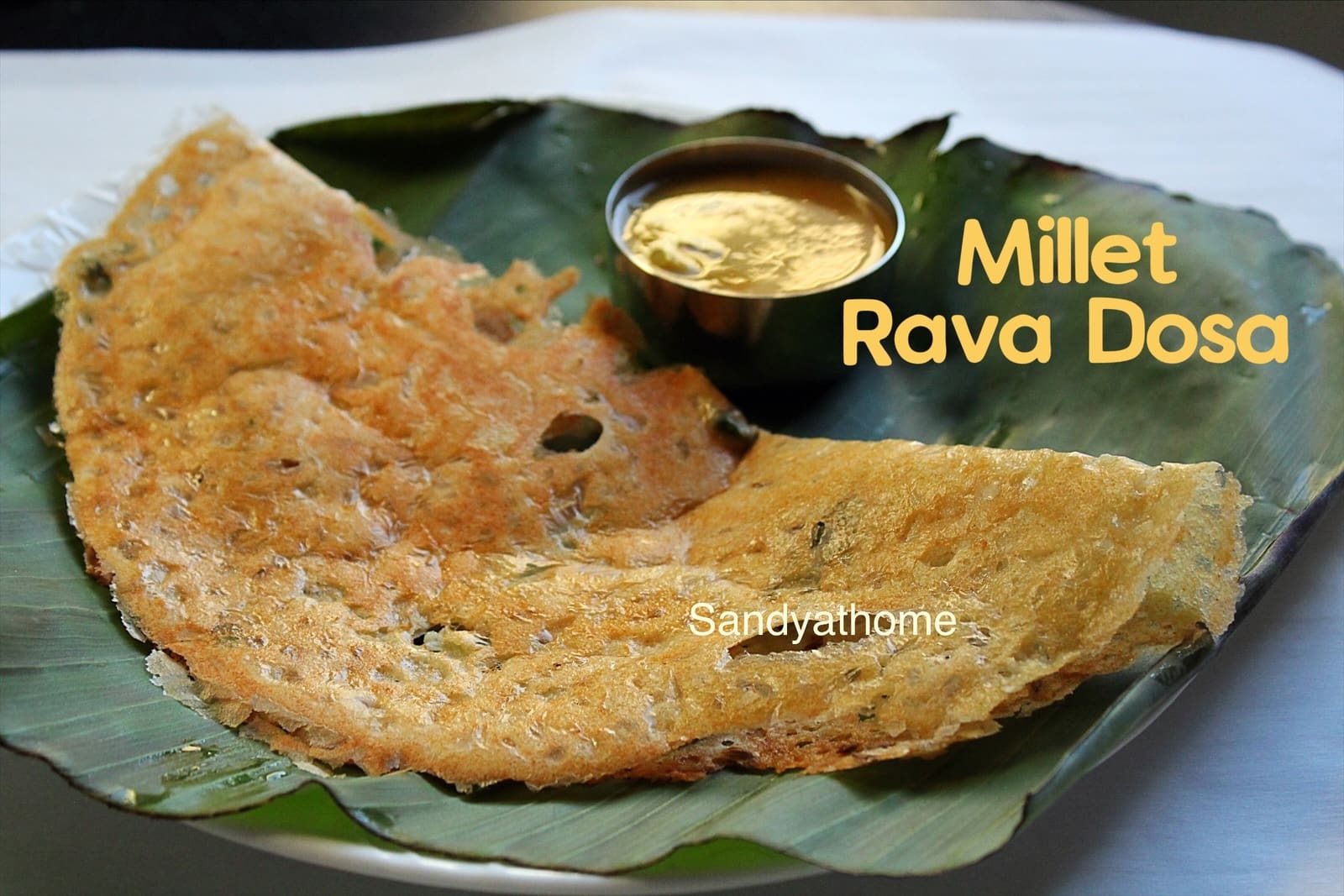 Millet rava dosa served as traditional Indian tiffin with chutney and sambar
