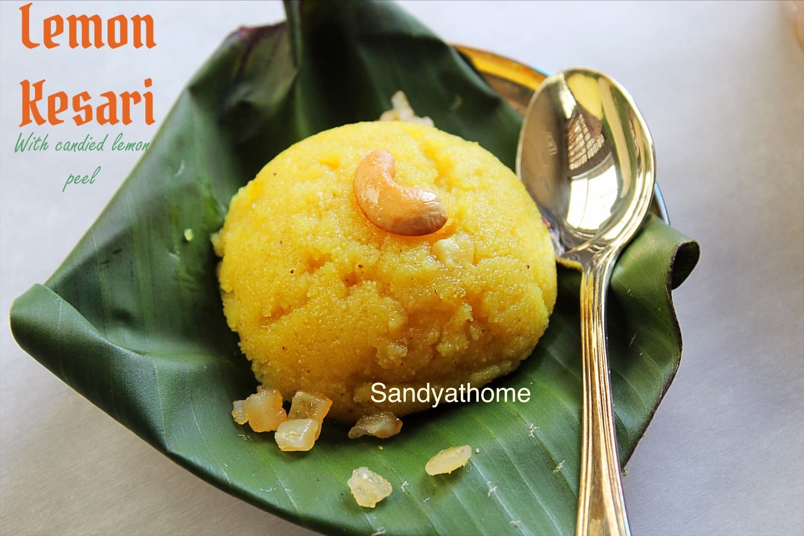 Golden sheera made without food color, placed on a rustic wooden tray with cardamom pods and lemon slices