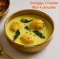 Traditional Tamil-style paruppu urundai mor kuzhambu served in a brass bowl with white rice – summer kuzhambu made with curd and steamed lentil balls.