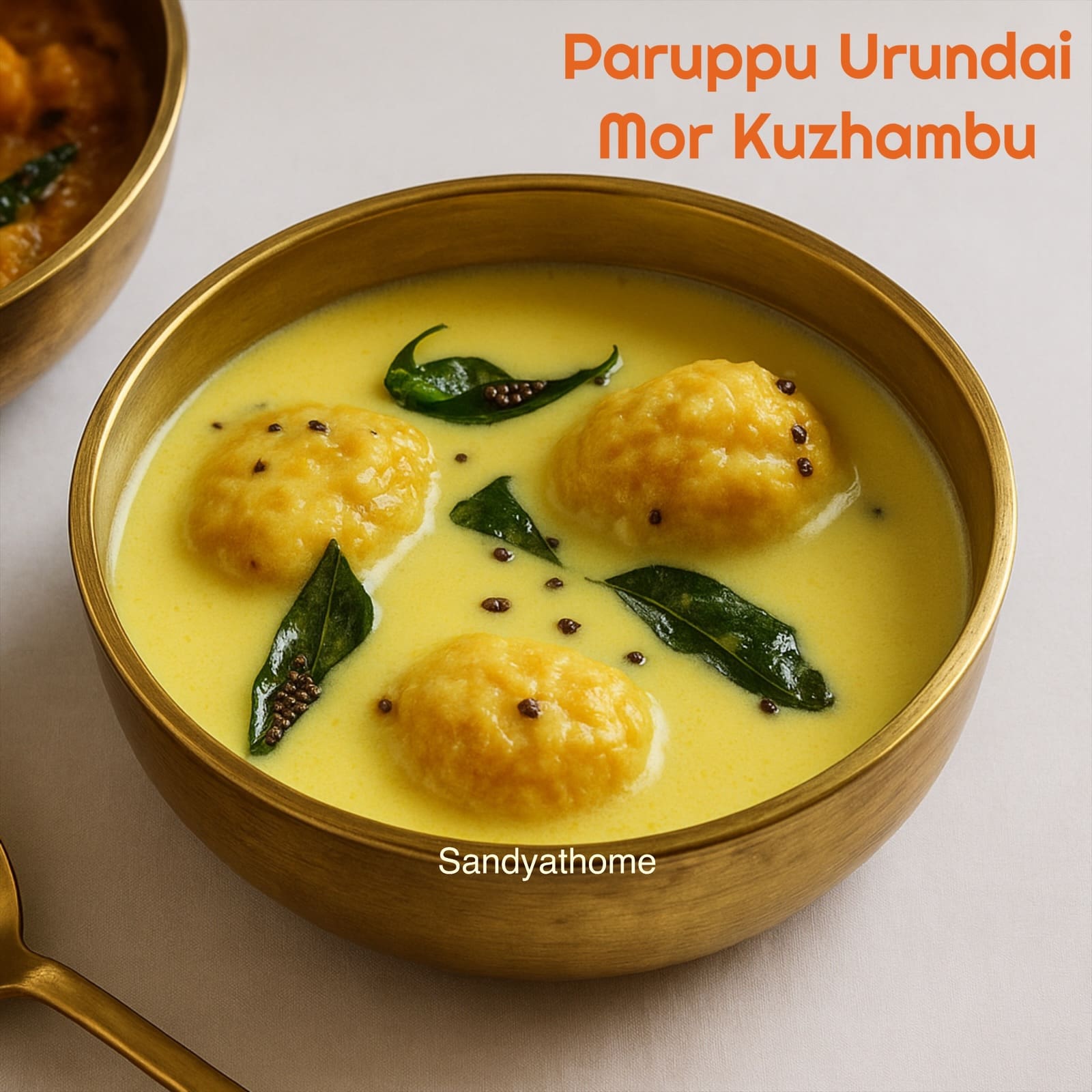 Traditional Tamil-style paruppu urundai mor kuzhambu served in a brass bowl with white rice – summer kuzhambu made with curd and steamed lentil balls.