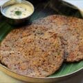 Traditional ragi adai batter dosa made with whole millets and dals being spread on a hot iron pan.