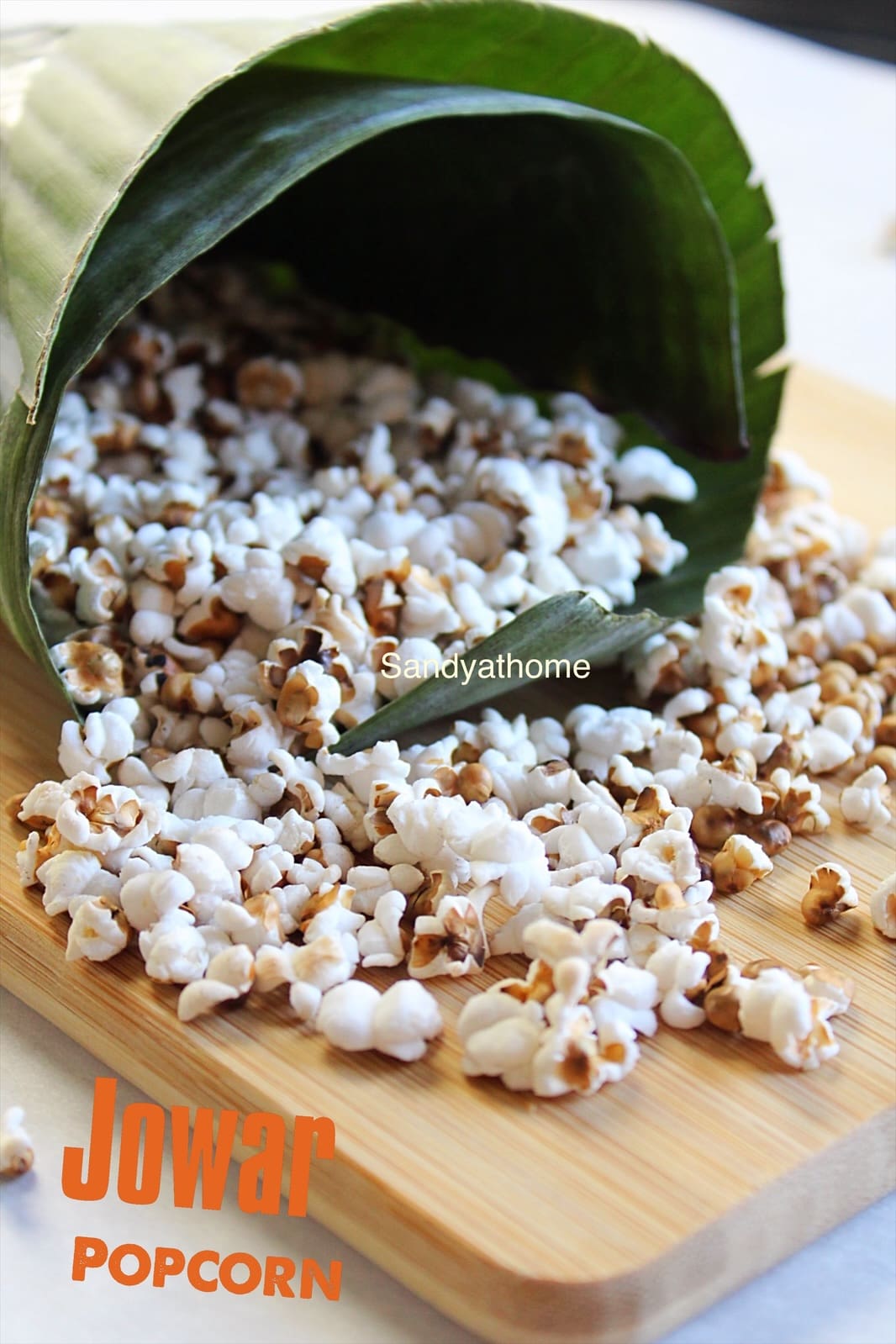 Millet popcorn served in a banana leaf cone – a traditional Indian millet snack made from puffed sorghum using a pressure cooker, oil-free and healthy.
