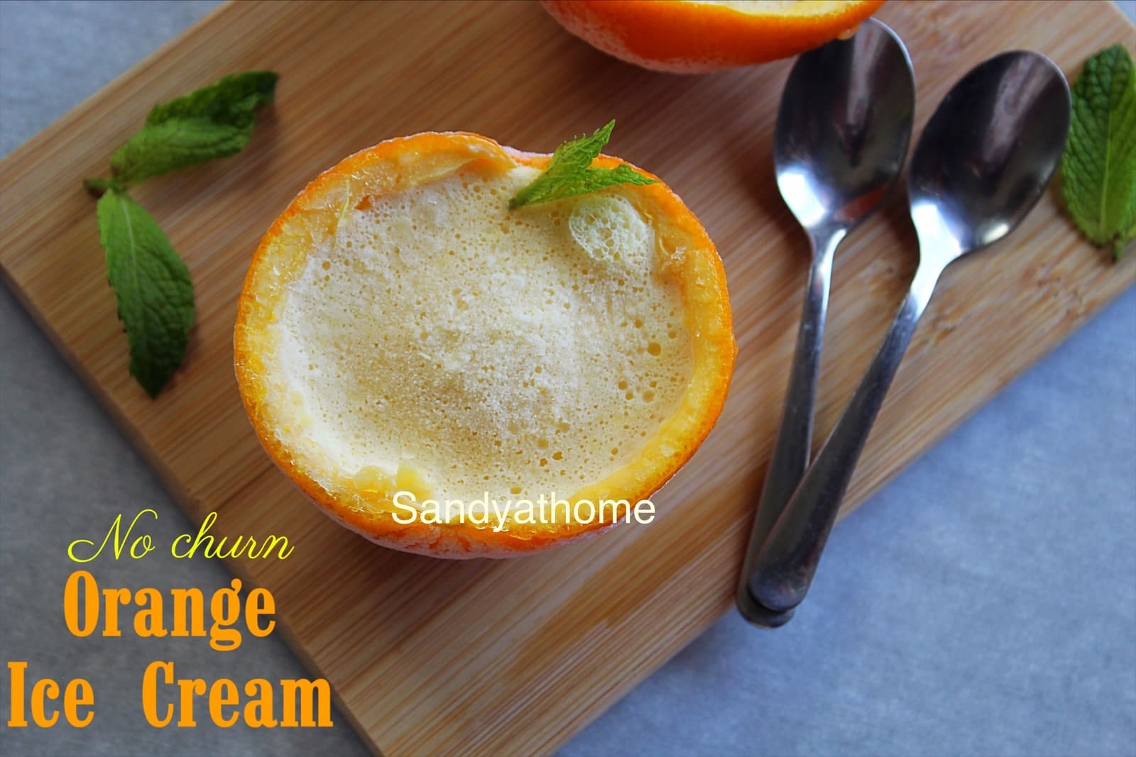 Indian-style summer ice cream served in orange shells, real fruit dessert with condensed milk and cream