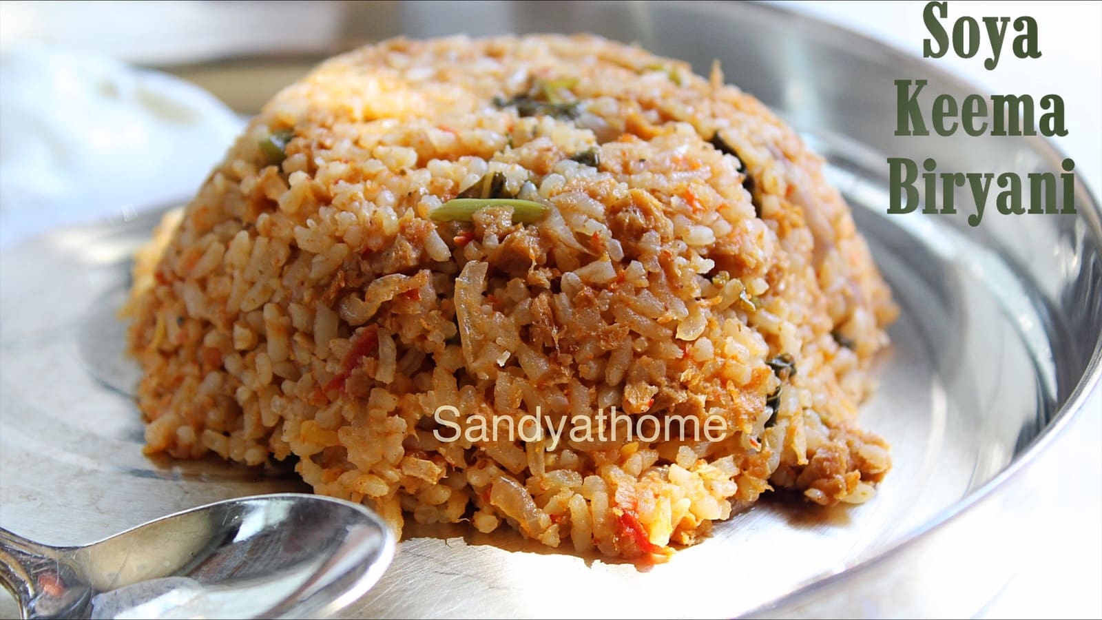 South Indian-style vegetarian keema biryani made using soya granules and aromatic spices, served in a brass pot.