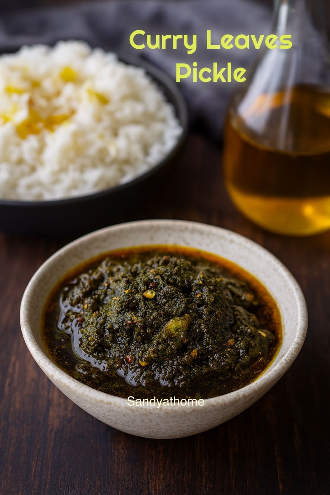 South Indian curry leaves pickle (Karuveppilai Nilavu Pachadi) served in a white bowl with gingelly oil shining on top
