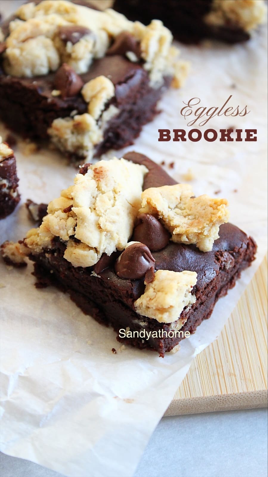 Close-up of eggless brookie bars with shiny crinkle top and gooey chocolate layers.