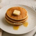 Eggless tofu pancakes made with whole wheat and all-purpose flour, served with fresh berries for a nutritious breakfast recipe.