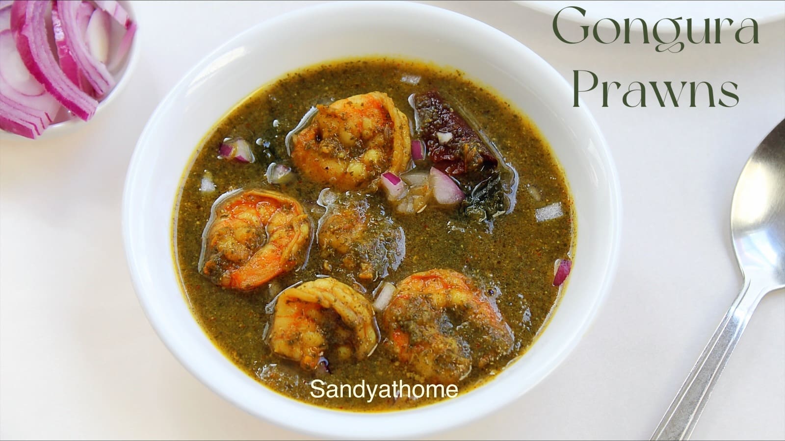 Tangy Andhra-style gongura prawns curry made with shrimp and sorrel leaves, served with rice.