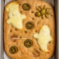 Soft golden focaccia made with 50–50 whole wheat and all-purpose flour, baked for Halloween.
