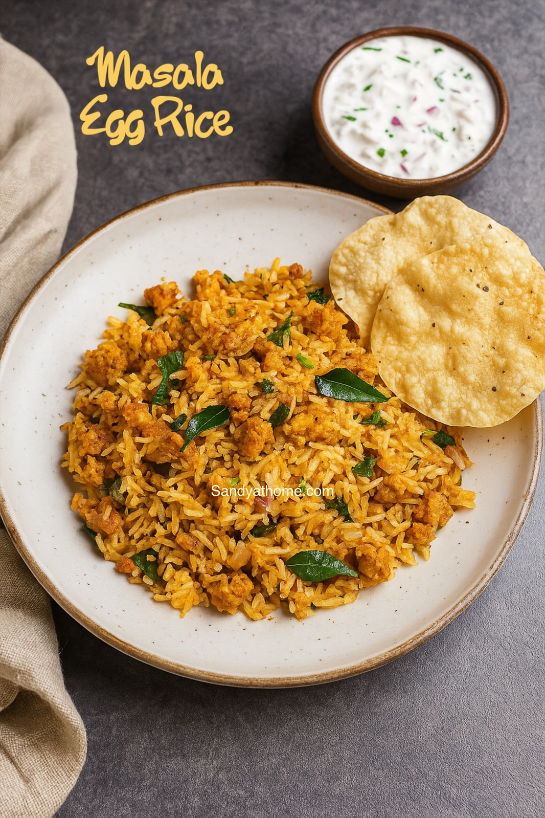 Close-up of no-tomato egg masala rice flavored with jeera and saunf, garnished with coriander and curry leaves.