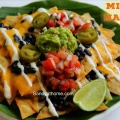 Healthy millet nachos served with homemade guacamole and fresh salsa for National Nacho Day