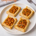 Festive baby corn masala puffs arranged for Christmas, featuring flaky pastry and warm spices