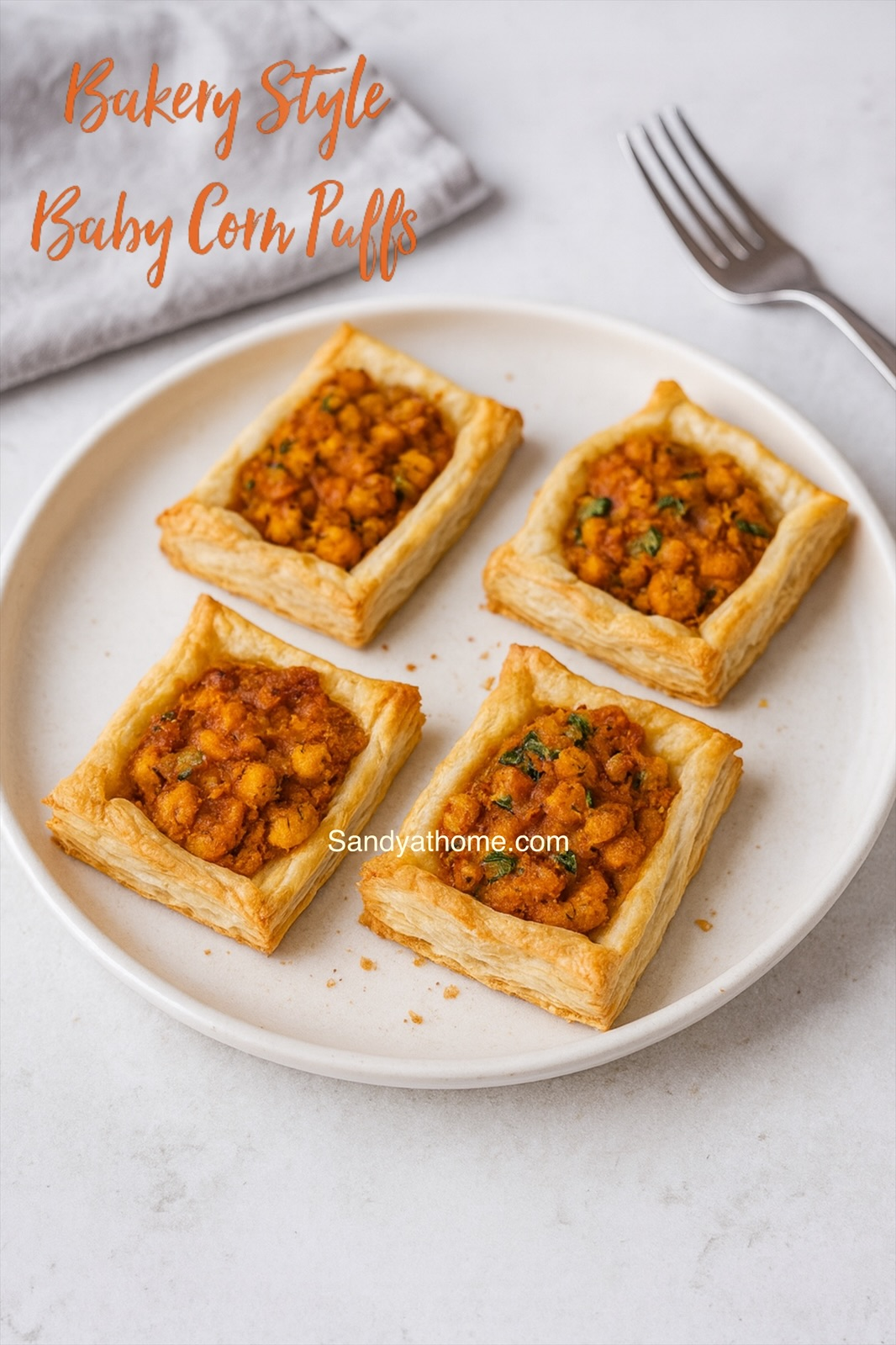 Festive baby corn masala puffs arranged for Christmas, featuring flaky pastry and warm spices