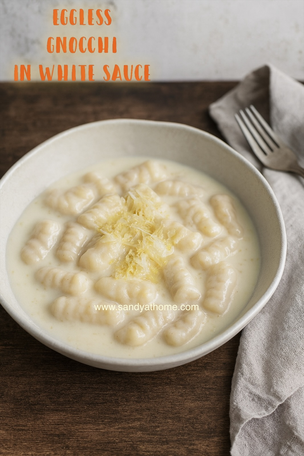 Homemade eggless potato gnocchi topped with a smooth, silky béchamel sauce.